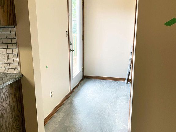 Access from Kitchen/Dining to Deck on left and Multi-use/Bedroom 4 to the right.