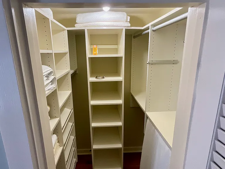 Primary bedroom walk in closet. One of two.