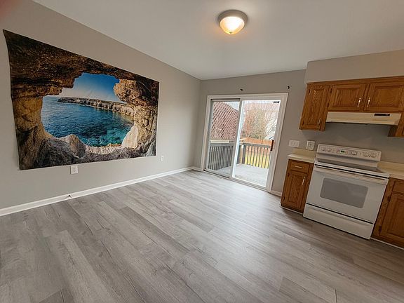 Open-concept dining and kitchen area, featuring modern appliances, ample counter space, and a welcoming, bright atmosphere