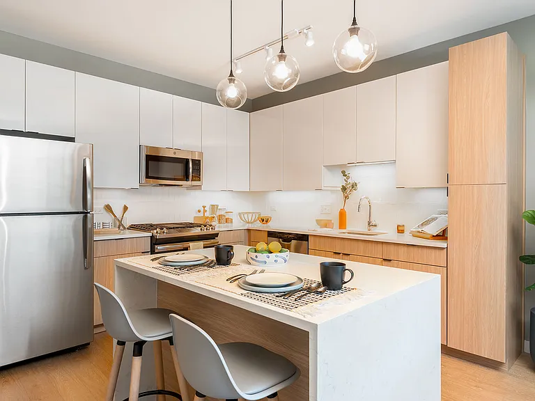 Bright, modern, and made for living this Eleven33 kitchen features stainless steel appliances, quartz countertops, and designer touches that make every day feel elevated.