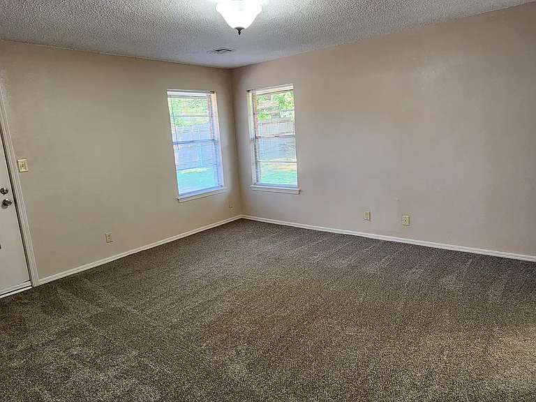 HUGE MASTER BEDROOM WITH IT OWN DOOR TO THE PATIO, A WALK-IN CLOSET ON THE LEFT AND MASTER BATH ON THE RIGHT.
