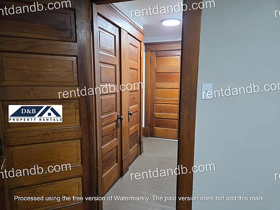 Hall view from bedroom with 2 closets and door to the bathroom