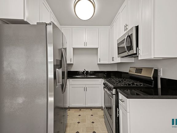 Kitchen with Stainless-Steel Refrigerator, Stove, Microwave Oven, and Ample Cabinet Storage
