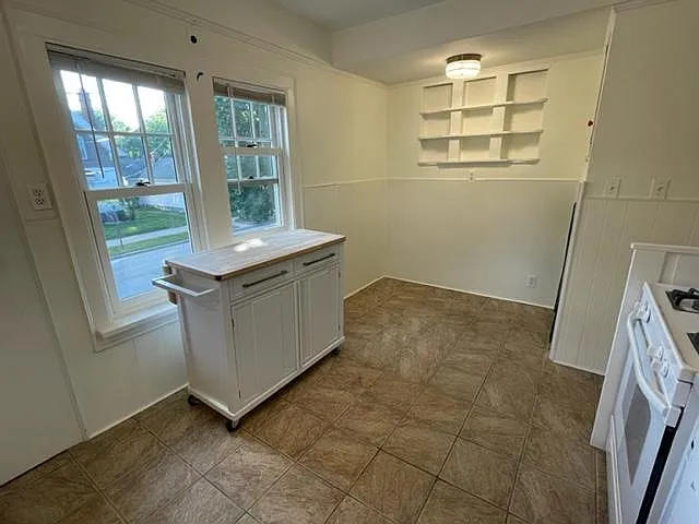 Kitchen, additional view showing breakfast nook and original built-in shelves.