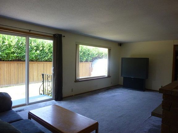 Large living room with easy access to outside patio. Fully fenced back yard as well.