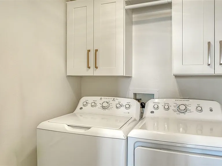 Laundry room in unit full washer and dryer.