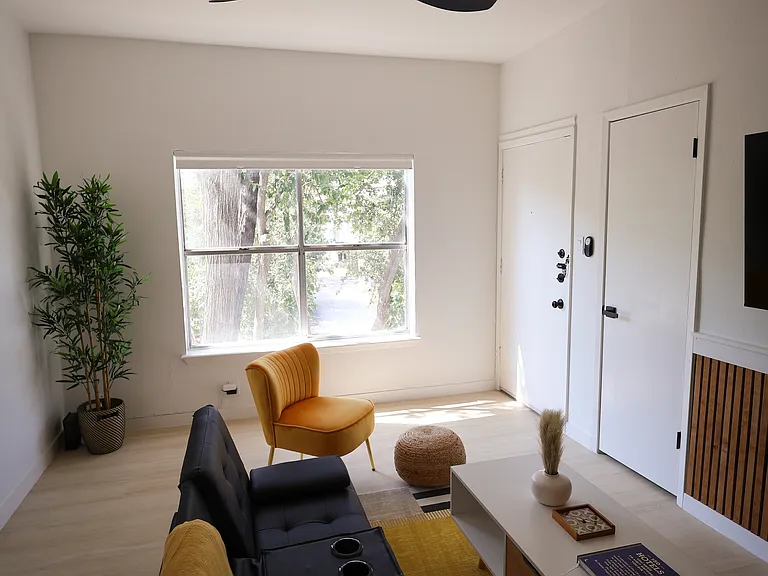 Living room has main entrance to apartment.