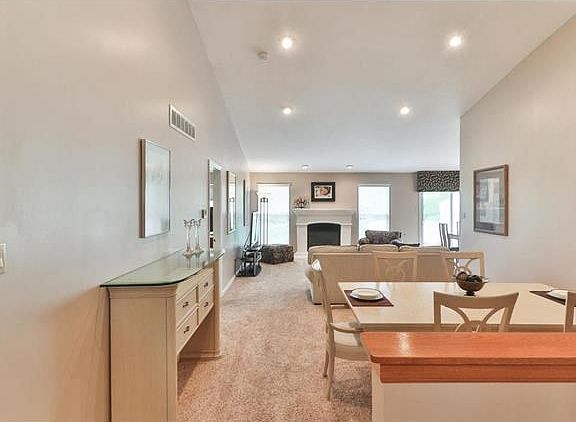 Enjoy a vaulted ceiling & canned lighting in the great room which boasts a fireplace w/stone mantle.