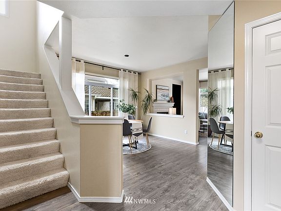 As you enter the home there's a powder room off to the right and then the dining room, and stairs to the 4 bedrooms.