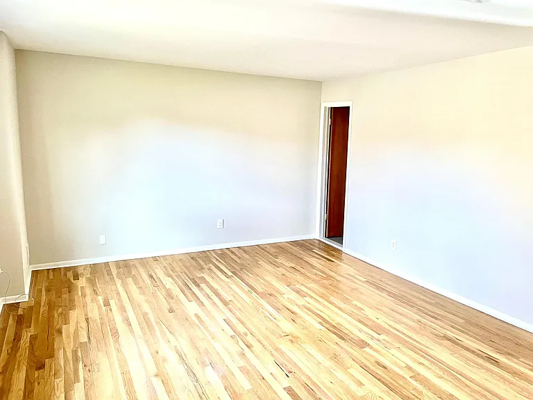Second half of primary bedroom with door to on-suite
