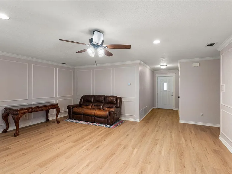 Spacious interior featuring wood-finish flooring, recessed lighting, and a ceiling fan