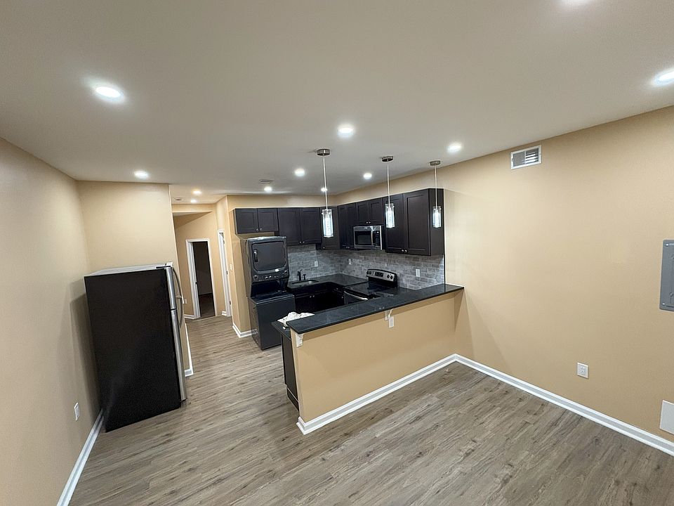 Open kitchen concept with recess lighting and over-the-bar spot lights.