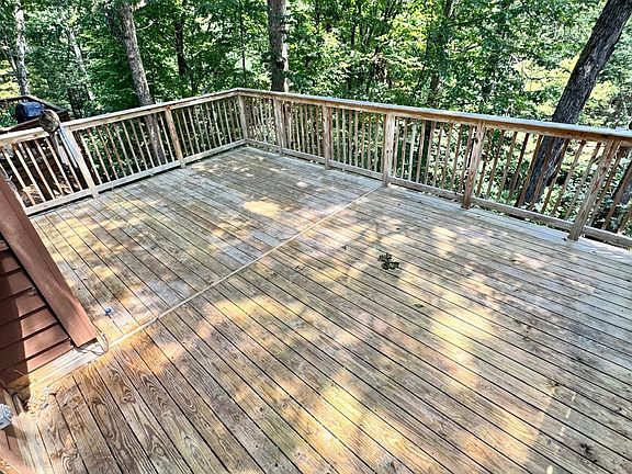 Private deck facing the woods with a view to stream. Sit here and relax while listening to the sounds of the water stream