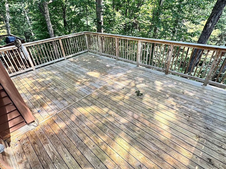 Private deck facing the woods with a view to stream. Sit here and relax while listening to the sounds of the water stream