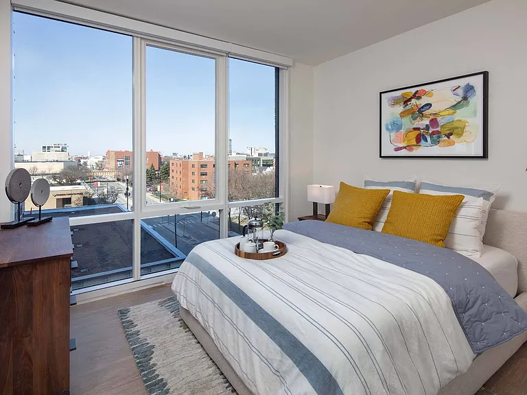 Wake up to natural light pouring in through a large window, filling the bedroom with warmth and creating a peaceful, bright retreat.