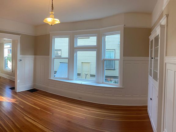Formal dining room with bay window and built-ins.