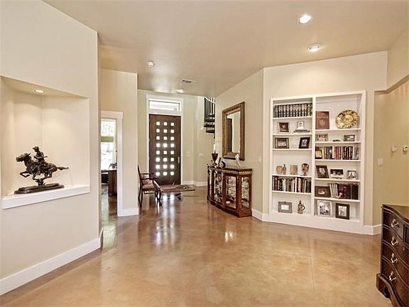 Elegant entry-foyer with built-in bookcases. Ample space for greeting guests when you entertain.