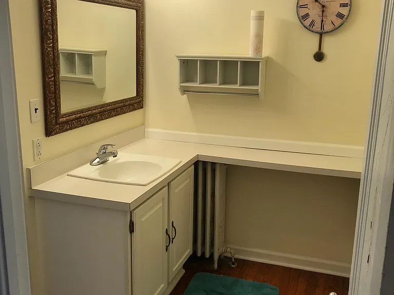 Vanity/changing area outside of bathroom and off bedroom.