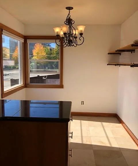 Bright breakfast nook. Custom-build shelves. Windows facing west and south.
