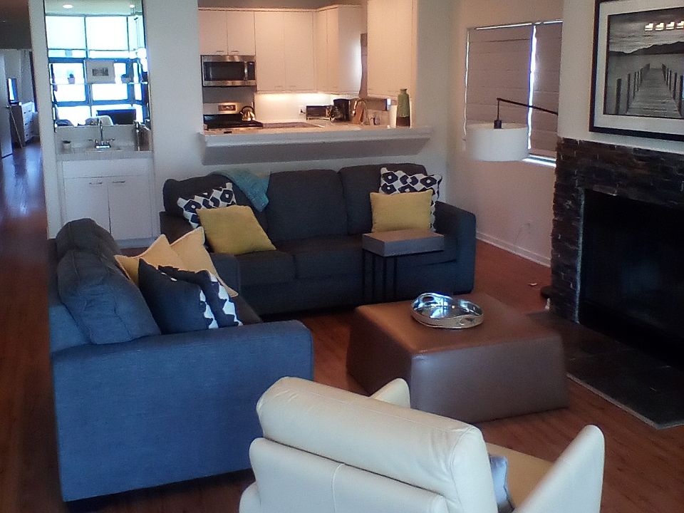 living room with hi ceilings recessed dimmed lighting and slate fireplace