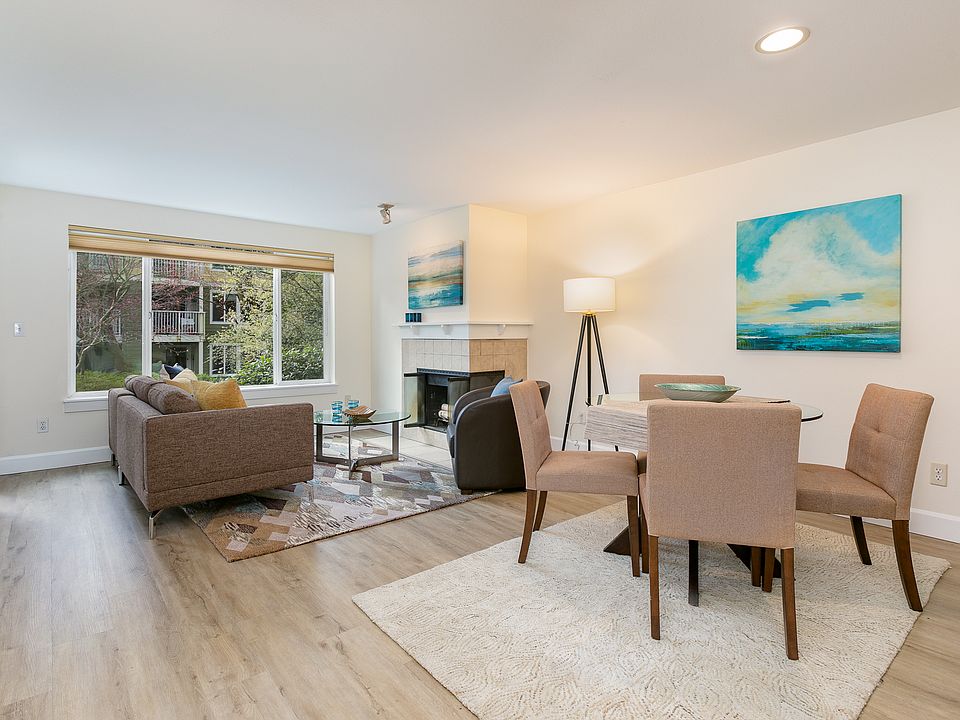 Bright open living and dining area with cozy fireplace