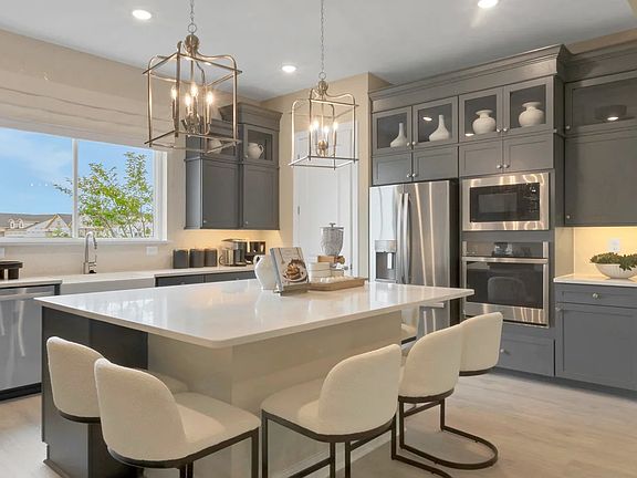 Kitchen with upper glass cabinets and pendant lighting