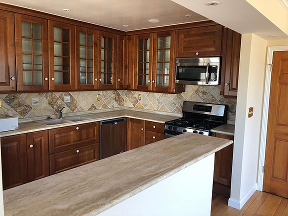 Remodeled kitchen with gas range and microwave hood