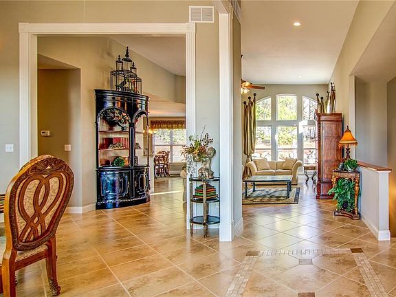 View from the Entry Foyer into the Great Room with 12 Ft Ceilings and Arched Windows...