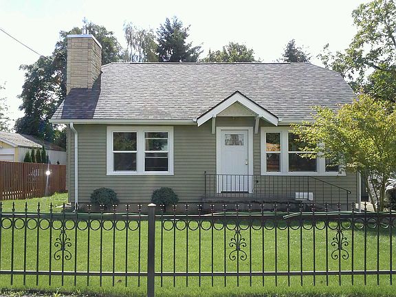 Landscaped yard & iron fence