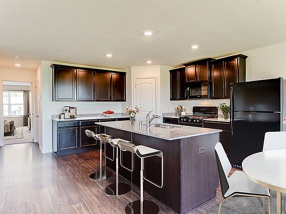 The Hennepin by LGI Homes at White Tail Ridge features an open kitchen with a spacious island.