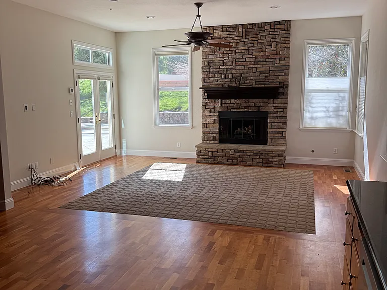 Family room fireplace with access to outdoor kitchen and pool area