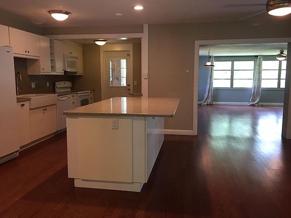 kitchen, dining, living. bar seats 4, storage on both sides