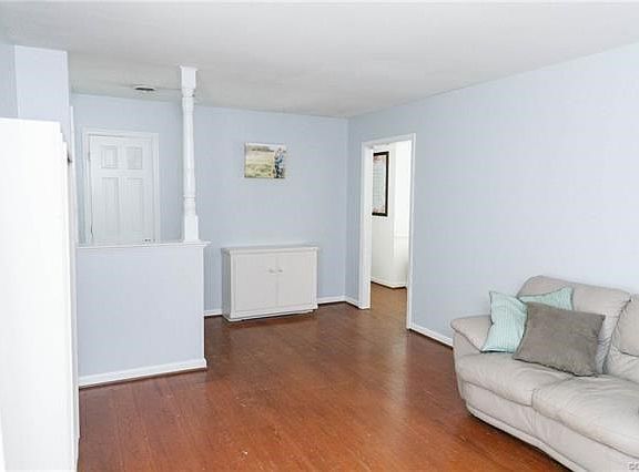 Large formal living room with hardwood floors.