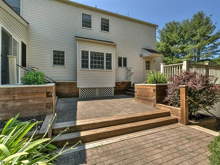 back of the house with an entry to the patio on the left, and to the house on the right.