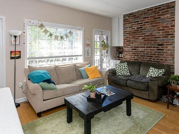 Living room area (fireplace behind olive colored couch; prior residents didn't use)