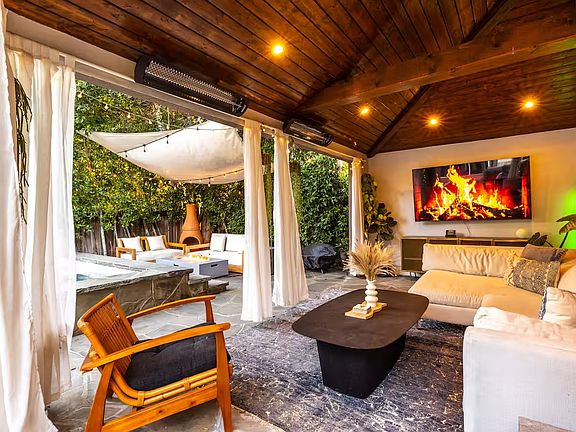 Outdoor lounge / patio with TV, next to pool