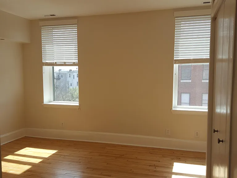 Sunny living room with recessed lighting and storage closet and cupboard