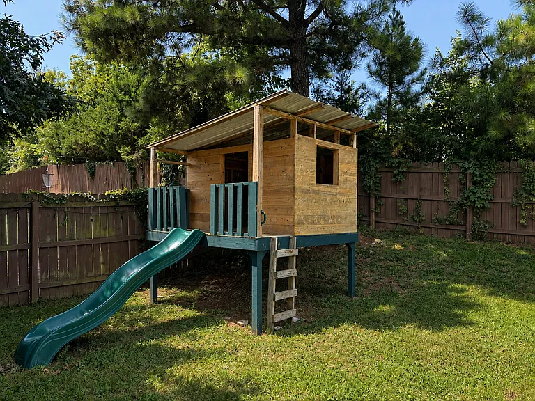Custom built playhouse in back yard