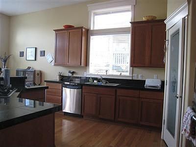 Spacious kitchen with eating bar and separate eating area. 12ft ceilings, hardwoods, pantry and fine