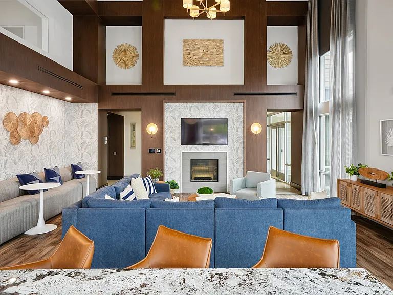 Resident lounge with seating, TVs and fireplace