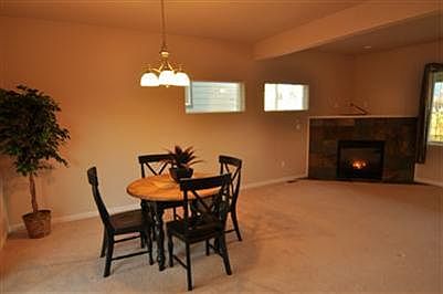 Enjoy open dining and living space in front of the gas fireplace. Fireplace is surrounded by slate t