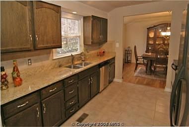 Kitchen w/ Granite Counters, Ceramic Tile, and Newer Appliances