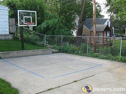 Cement Basketball Court in backyard