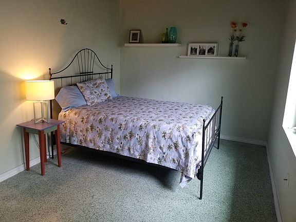 Bedroom with high wood ceilings as in living room