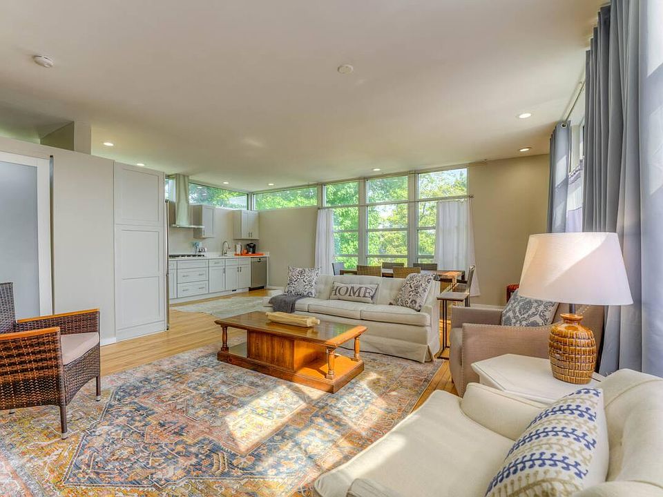 Open living area with lots of natural light, privacy curtains with blackout included