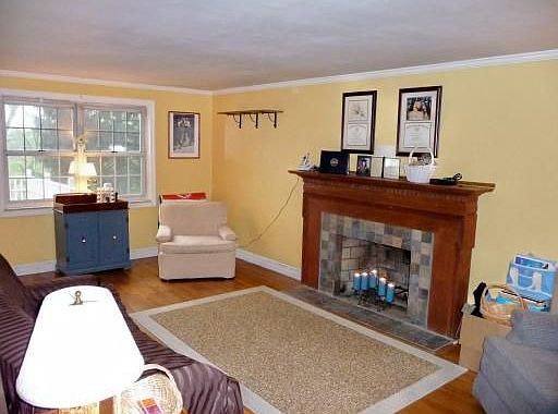 Living Room with hardwood floor and tiled fireplace.