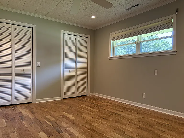 Secondary bedroom with its own private full bathroom, offering added comfort and convenience for guests or family members.