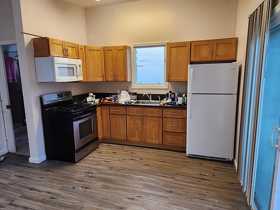 kitchen with gas stove, microwave and refidgerator