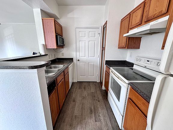 Kitchen with glass cooktop range, microwave, refrigerator, and dishwasher