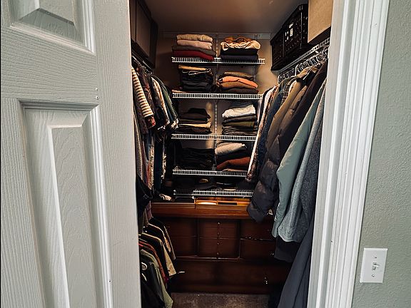 Walk-in closet with built-in shelving and storage